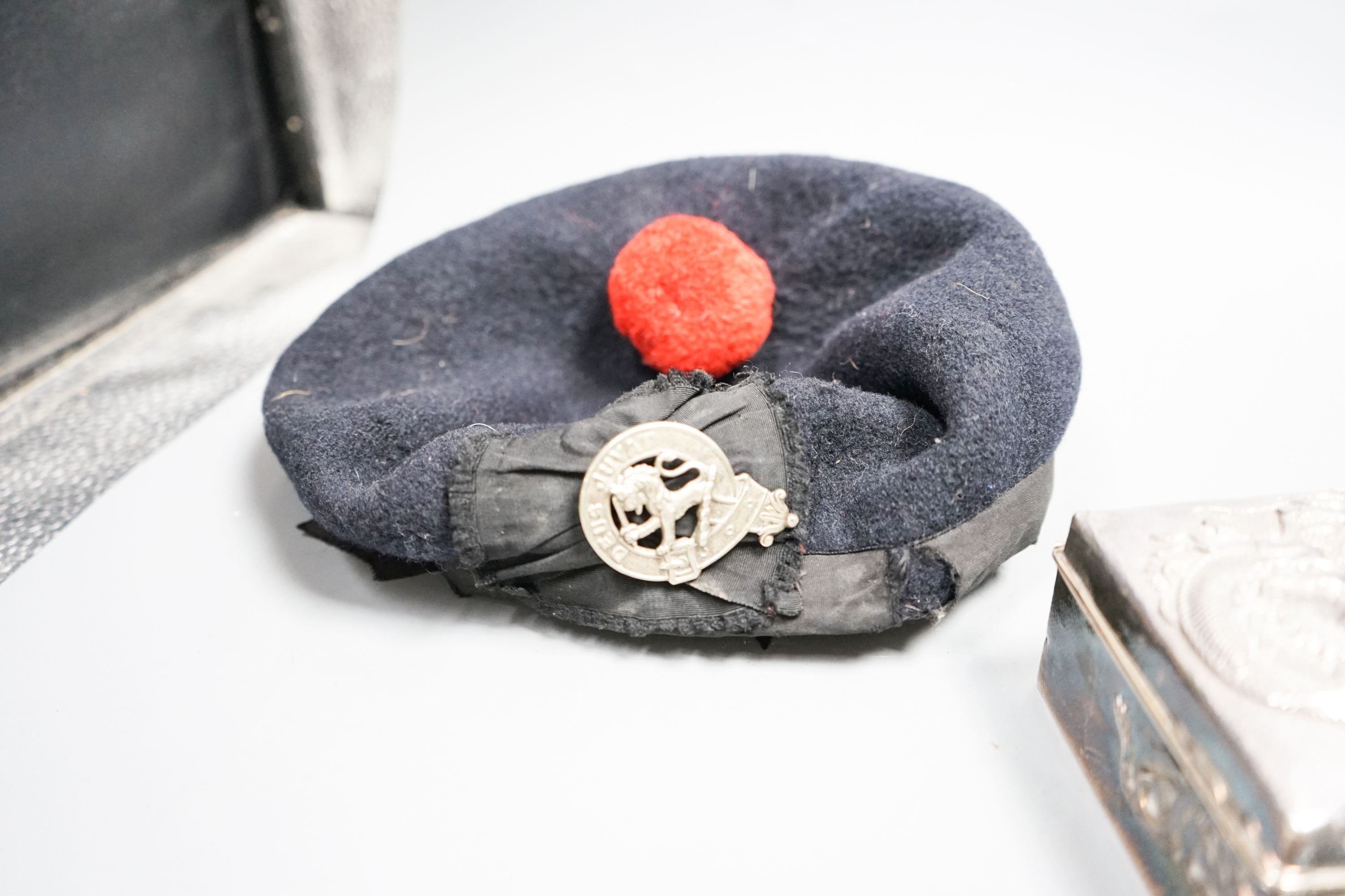 A Japanese silver box, bracelet, medal and military cap